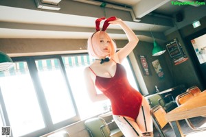 A woman in a bunny costume sitting at a table.
