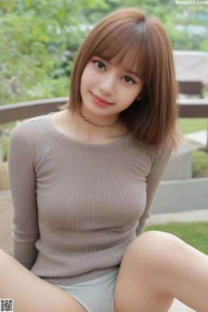A woman in a black dress posing for a picture.