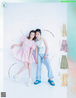 A couple of young women laying on top of a table.