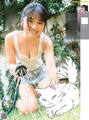 a japanese woman in a purple sweater is posing for a magazine