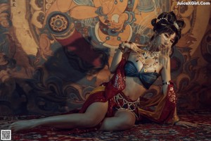 A woman in a belly dance costume posing for a picture.