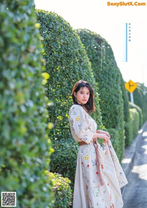 A woman with long black hair is posing for a picture.