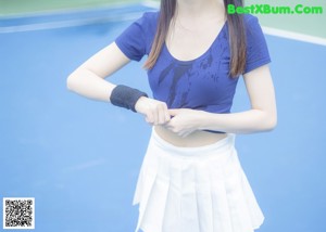 A woman wearing a white shirt and a white bra.