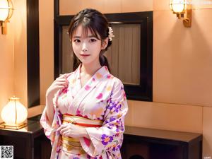 A woman in a white kimono sitting on a table.