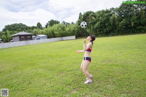 A woman in a red, white and blue outfit is posing for a picture.