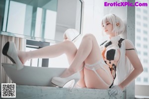 A woman sitting on top of a bed in lingerie.