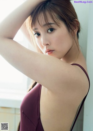 A woman in a white dress posing for a picture.
